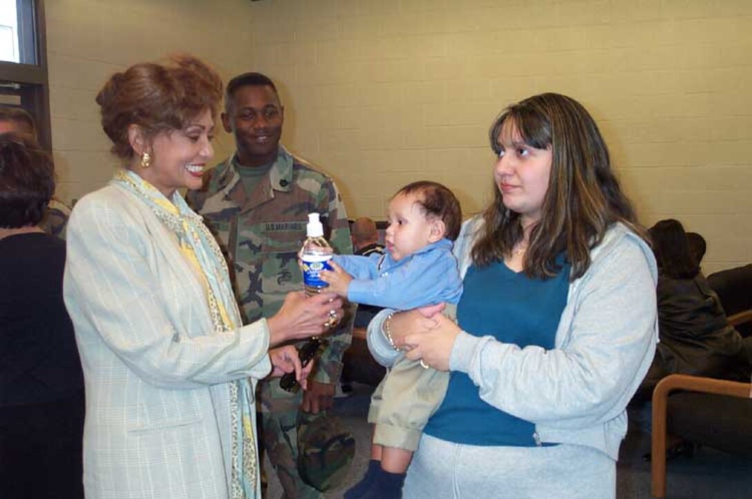 Janet Langhart Cohen spends a moment visiting with six-month-old David Pacheco Jr. and his mom, Candida Pacheco at a homecoming celebration at Camp Pendleton, Calif., for Battery E, 2nd Battalion, 11th Marines. Lance Cpl. David Pacheco deployed with the unit the week before his son was born. Photo by Staff Sgt. Kathleen T. Rhem, USA. 