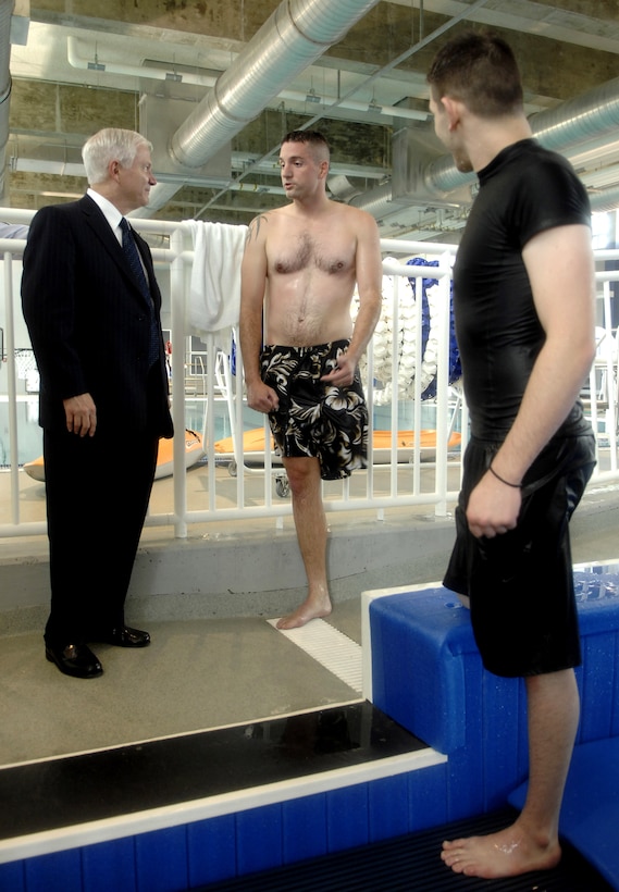 Defense Secretary Robert M. Gates visits with wounded Pfc. Patrick Moore (right) and Petty Officer 2nd Class Derek McGinnis during a visit to the Center for the Intrepid at Brooke Army Medical Center on Fort Sam Houston, Texas, May 3, 2007. 