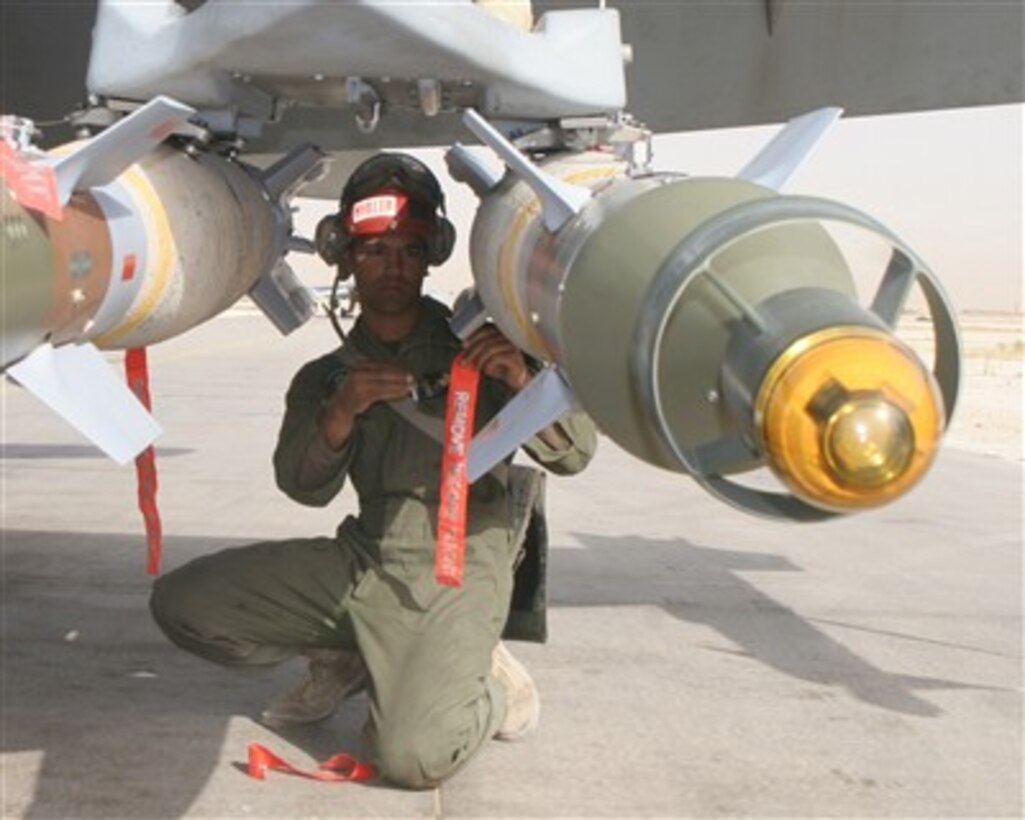 U.S. Marine Corps Lance Cpl. Derek Hibler takes the covers and pins off of a GBU-12 on an F/A-18D Hornet aircraft before it launches from Al Asad Air Base, Iraq, on April 23, 2007.  Hibler is assigned as an ordnance technician with Marine All Weather Fighter Attack Squadron 121.  