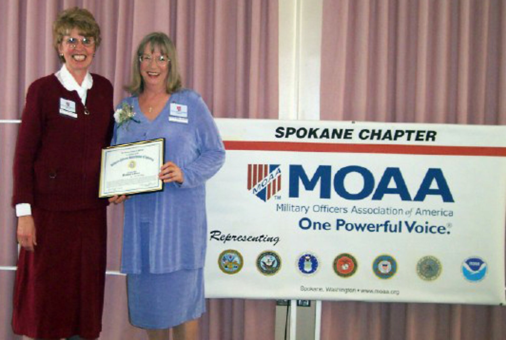 FAIRCHILD AIR FORCE BASE, Wash. -- Marilyn Hunt (left), president of the Spokane chapter of the Military Officers Association of America, presents the chapter’s President’s Award to Beth Ann Daigre April 22 for her performance and contributions.
