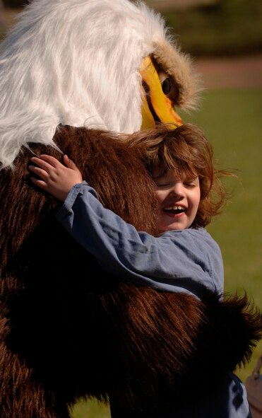 Natalie Muller of Wiesbaden gets a hug from the Armed Forces Network Eagle mascot during the 2007 Special Olympic Games May 2 in Enkenbach-Alsenborn, Germany. Numerous German and American volunteers from the Kaiserslautern military community assisted more than 750 Special Olympians who competed in the 24th annual games here. (U.S. Air Force photo/Master Sgt. Scott Wagers) 
