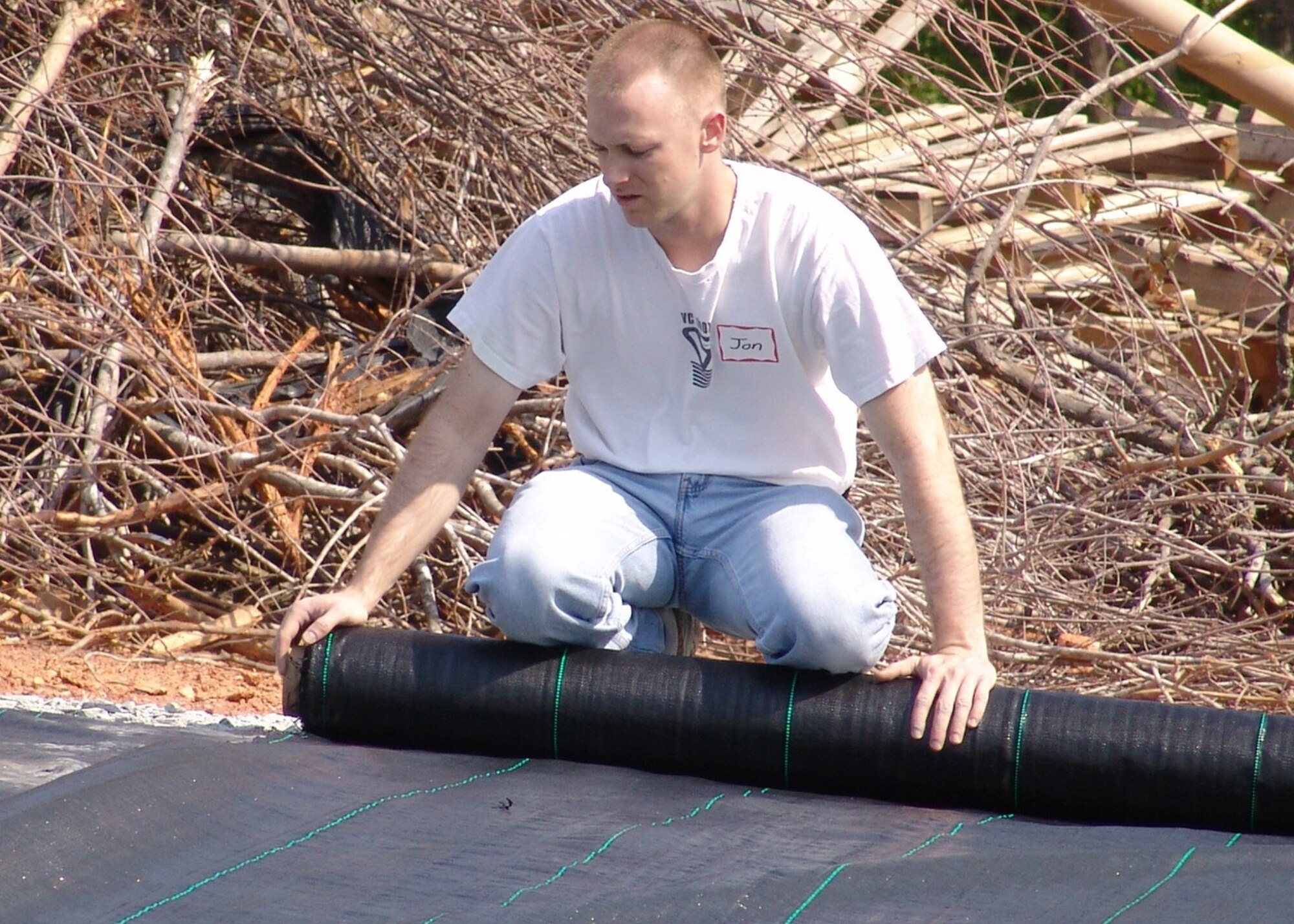 Staff Sgt. Jonathan Bish, 337th Recruiting Squadron enlisted accessions recruiter from Hickory, N.C., lays out a landscaping tarp April 26, providing a holding area for hundreds of shrubs and flowers slated for planting all over Victory Junction Gang Camp’s 72-acres. Sergeant Bish was one of 27 recruiting squadron volunteers who helped landscape around the camp’s tree house. (U.S. Air Force photo by Tech. Sgt. Michael Asdel)