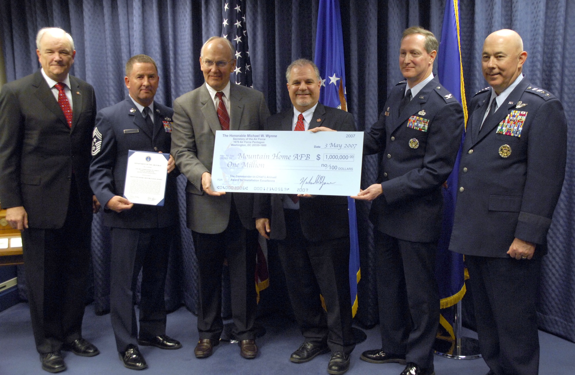 Secretary of the Air Force Michael Wynne, the 366 Fighter Wing Command Chief Allen Niksich, Idaho senator Larry Craig, Congressman Bill Sali, the 366th Mission Support Group commander Col.Tom Laffey and Air Force Chief of Staff T. Michael Moseley pose for a photo on May 3 with a $1 million check after the presentation of the 2007 Installation Excellence Award to Mountain Home Air Force Base, Idaho at the Pentagon in Washington, D.C. Standing out among the many great improvements made on the base was their robust energy program where they installed new boilers in multiple facilities, reducing heating costs by $1.2 million and later renegotiated natural gas rates, which slashed costs 24 percent, which in turn saved the base $800,000. (U.S. Air Force photo/Tech. Sgt. Cohen A. Young