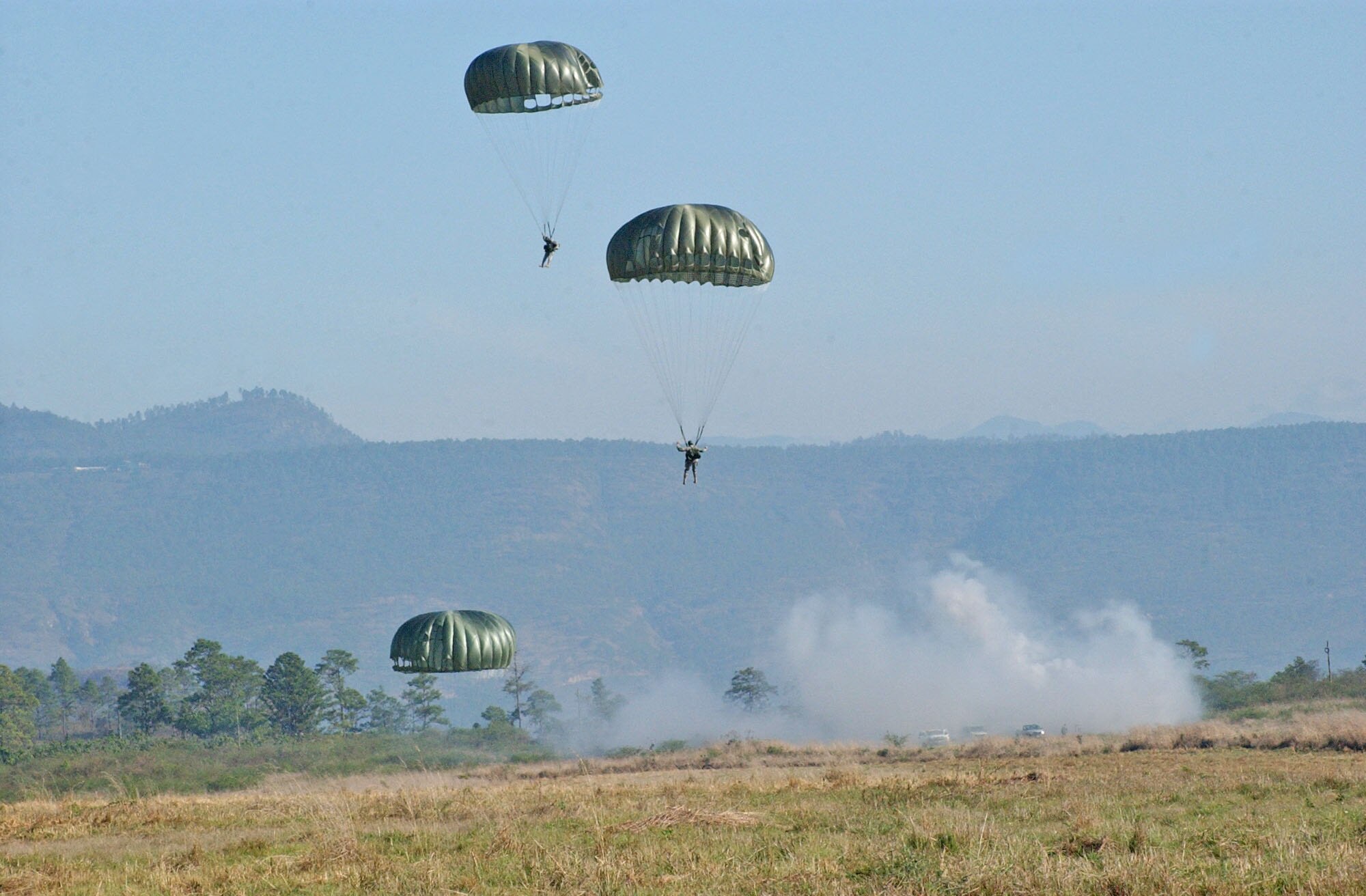 TAMARA DROP ZONE, Honduras – Paratroopers land on the drop zone during Iguana Voladora, an annual exercise that includes military members from across Central and South America.  Joint Task Force-Bravo hosted Iguana Voladora, an annual paratrooper exercise, April 29 through May 4 and hosted more than 50 paratroopers from Central and South America for the week.   (U.S. Air Force photo/Tech. Sgt. Sonny Cohrs)