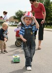 Justin Harter, 3, keeps his "Uncle Sam" hat from falling over his eyes as he pulls his float in the Month of the Military Child Shoebox Parade on April 27 around the Family Child Care Office at Kenly and Selfridge Avenues on Lackland Air Force Base, Texas. He is the son of Staff Sgt. Ryan and Lisa Harter. "It was an awesome turnout," said Tina Matthews,  Family Child Care Support Group president and event planner. She said the parade included 25 to 30 floats. "The children enjoyed pulling their floats, and especially making them at home with their parents," she said. "We had great support from parents and providers as well." (USAF photo by Robbin Cresswell)