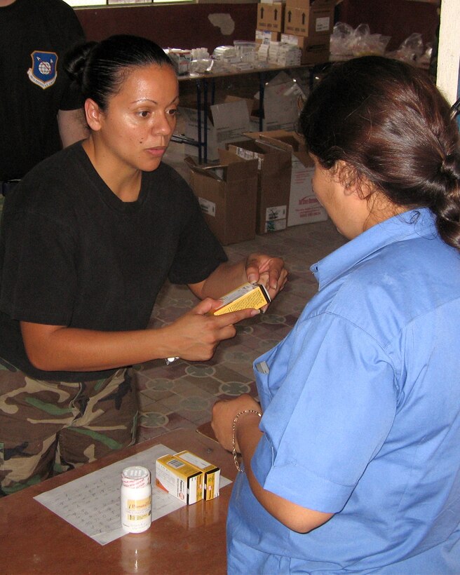 Staff Sgt. Nilsa Ramos, a pharmacy technician from Patrick AFB, Fla., dispenses medicine to a Guatemalan woman during a humanitarian mission to the area in the final 10 days of April.  The team of 13 medical professionals from Air Force Space Command saw more than 8,000 patients during that period. (U.S. Air Force Courtesy Photo)