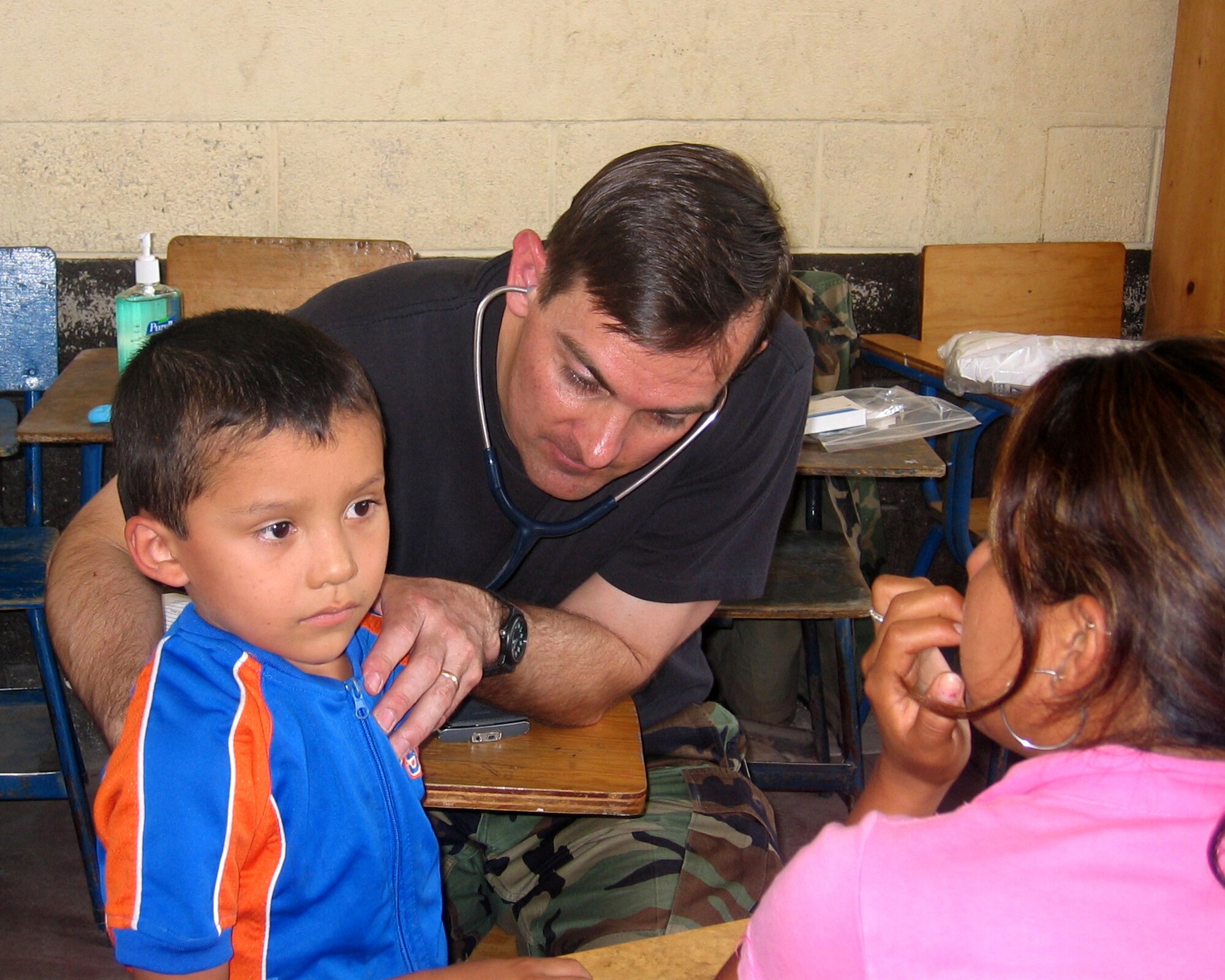 Maj. (Dr.) Michael Stevens, a pediatrician from Peterson AFB, Colo., listens to the heartbeat of a Guatemalan child as the boy’s mother looks on.  Doctor Nelson was part of a team of 13 medical professionals from Air Force Space Command that was sent to Guatemala for a humanitarian mission during the final 10 days of April.  The team saw more than 8,000 patients during that 10-day period. (U.S. Air Force Courtesy Photo)