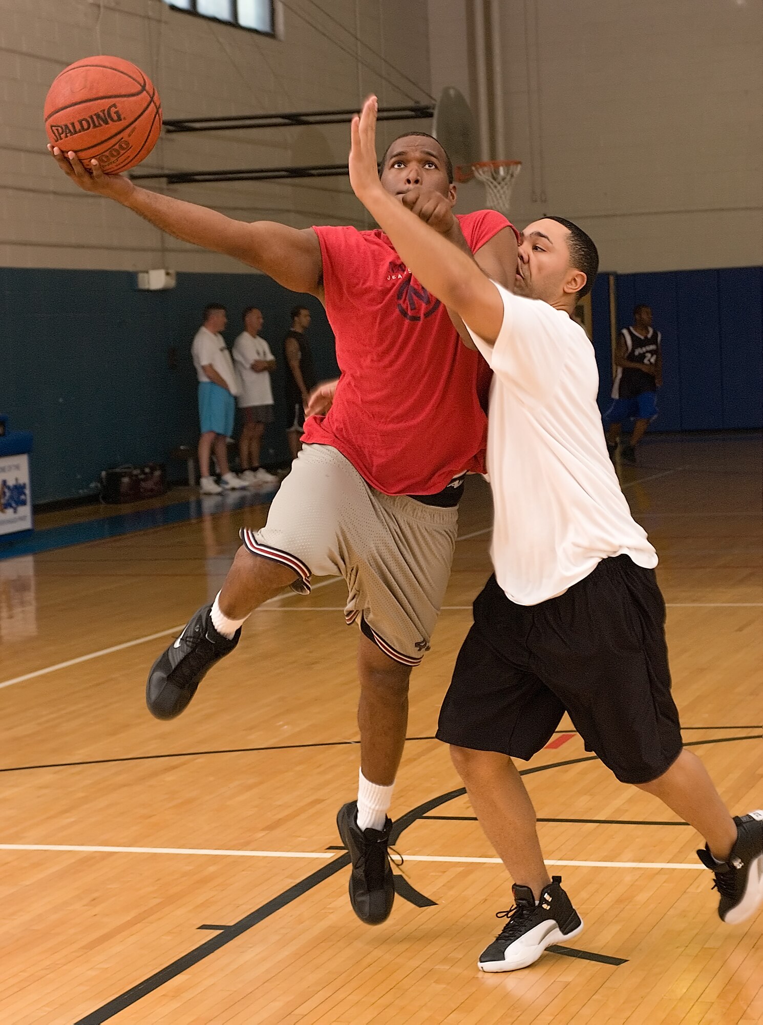 DOVER AIR FORCE BASE, Del. -- Staff Sgt. Anthony Haylock, 436th Communications Squadron, tries a lay up against Senior Airman Anthony Smith during the basketball tournament Wednesday. (U.S. Air Force Photo/Jason Minto)