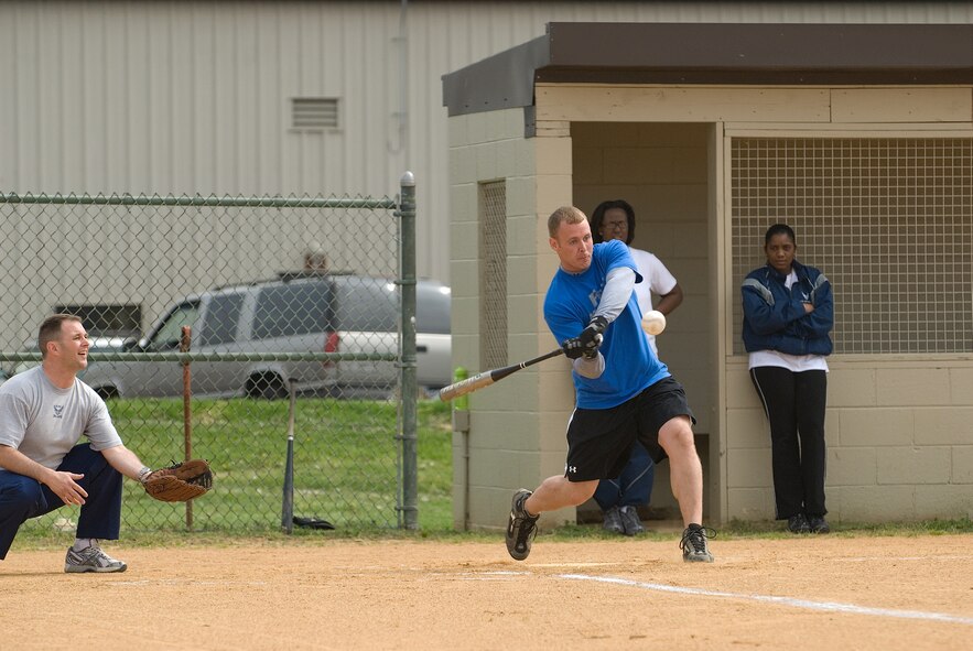 DOVER AIR FORCE BASE, Del. -- Staff Sgt. Joseph Kernan, 436th Communications Squadron, crushes a hit during Wednesday’s softball tournament versus the 436th CES. Dover held a Wing Sports Day sponsored by the Company Grade Officers Council and the 436th Security Forces Squadron. Squadrons on base competed against each other to build camaraderie and take home the first-place trophy.  Despite everyone's best efforts, the 436th Medical Group took top honors for the second straight time. (U.S. Air Force photo/Roland Balik)