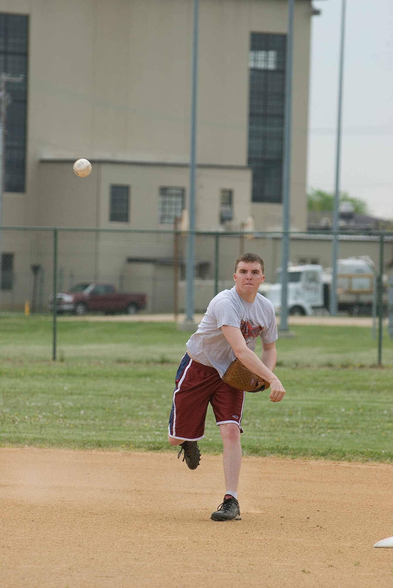 DOVER AIR FORCE BASE, Del. -- Airman 1st Class Rob Schmid, 436th Civil Engineer Squadron Explosive Ordnance Disposal Flight, who was playing short stop for 436th CES, launches a ball toward first base during the softball tournament. The 436th Security Forces Squadron took first place in the softball tournament. (U.S. Air Force photo/Roland Balik)
