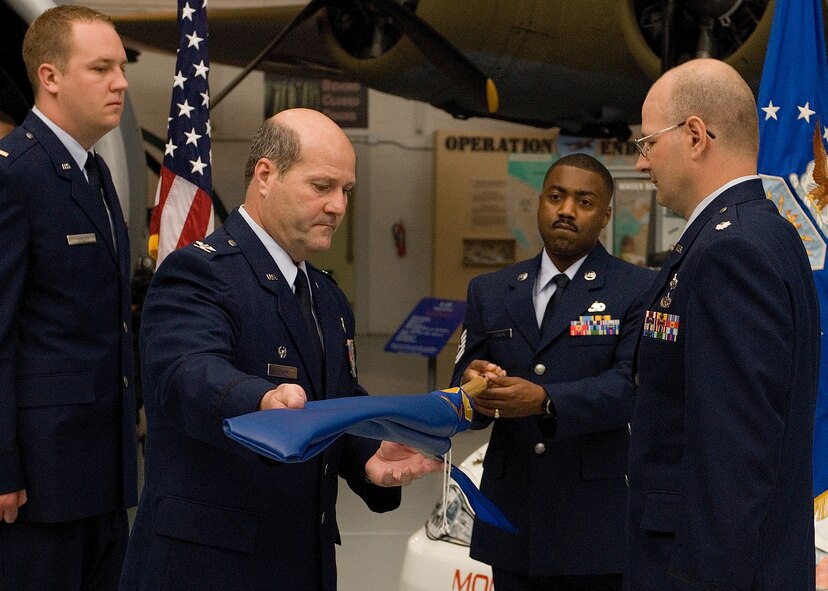 DOVER AIR FORCE BASE, Del. -- Col. Robert Hamm, 436th Maintenance Group commander, uncases the guidon of the new 736th Aircraft Maintenance Squadron before handing it to Lt. Col. Raymond Briggs, 736th AMXS commander. (U.S. Air Force photo/Roland Balik)
