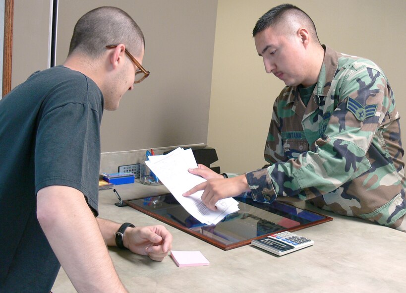 Senior Airman Ricardo Quintana, 23rd Comptroller Squadron, offers assistance to a customer with financial questions May 4. The Air Force Financial Management system will begin a transformation soon, which will eventually leave Moody with five comptroller positions. (U.S. Air Force photo by Airman 1st Class Eric Schloeffel)