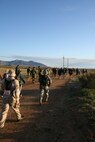 Soldiers and civilians stretch out toward the horizon as the mountains of New Mexico loom in front of them. This part of the march was still early in the morning. The participants of the march still have more than 24 miles to go in the 26-mile trek. (USAF photo by Army Spc. Tim Luukkonen)