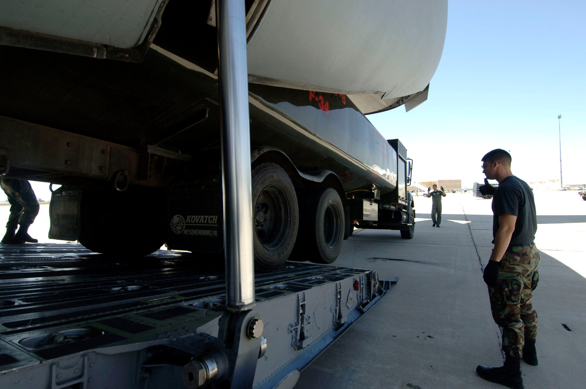 A Charleston Air Force Base, S.C., loadmaster trains augmentee loadmasters on how to properly load a vehicle onto a C-17 Globemaster III April 28 at Davis-Monthan AFB, Ariz. (U.S. Air Force photo/Staff Sgt. April Quintanilla)