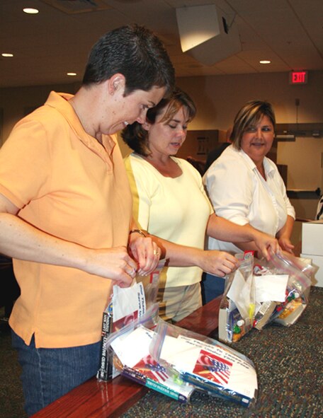 Spouses of the 1st Special Operations Group assemble care packages Sunday in the 16th Special Operations Squadron. More than 650 care packages will be sent out to Hurlburt Field Airmen in deployed locations. (U.S. Air Force photo by Jamie Haig)