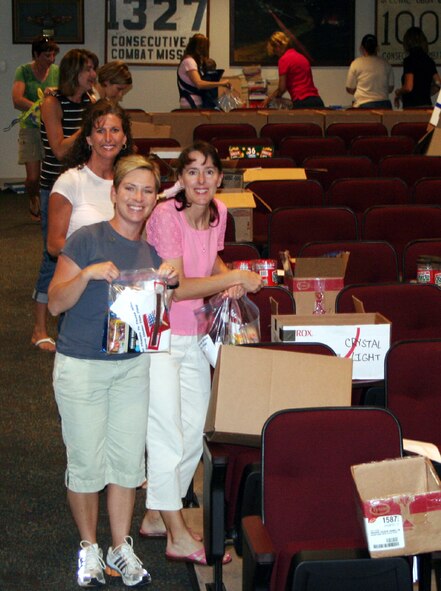 Spouses of the 1st Special Operations Group assemble care packages Sunday in the 16th Special Operations Squadron. More than 650 care packages will be sent out to Hurlburt Field Airmen in deployed locations. (U.S. Air Force photo by Jamie Haig)