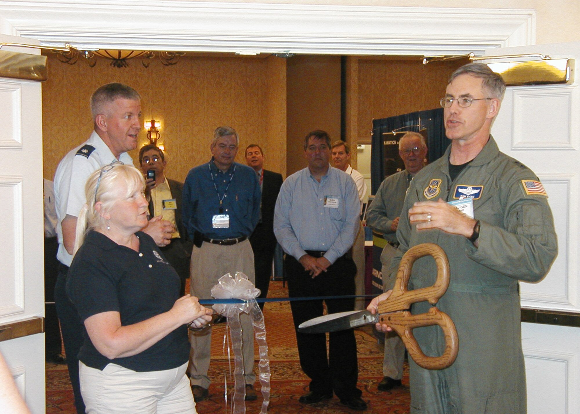 Maj. Gen. Thomas Kane (right), Air Mobility Command's director of Strategic Plans, prepares to cut the ribbon opening the vendor area at this year's Communication, Navigation, Surveillance and Air Traffic Management Conference in Orlando, Fla., along with Claire Goulet from the Lexington-Concord Chapter of AFCEA and Lt. Col. Michael Harrington, the Electronic Systems Center's Global Air Traffic Management division chief. (Courtesy photo)
