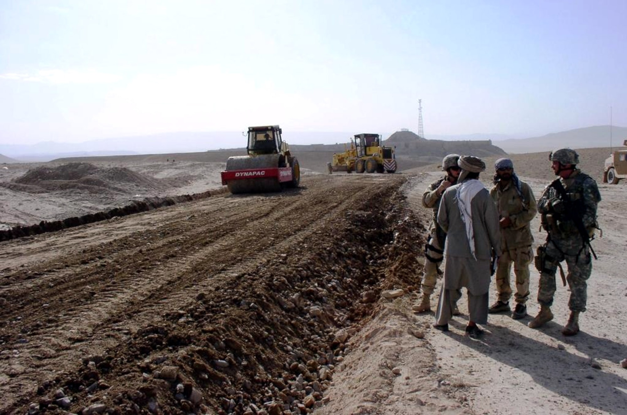 Qalat Provincial Reconstruction team members talk with a local Afghan near the Qalat to Mizan road project, a 70-mile highway artery in southwestern Afghanistan. About 240 Airmen are stationed throughout Afghanistan as part of PRTs working to improve the country's security through reconstruction and economic development. (U.S. Air Force photo)