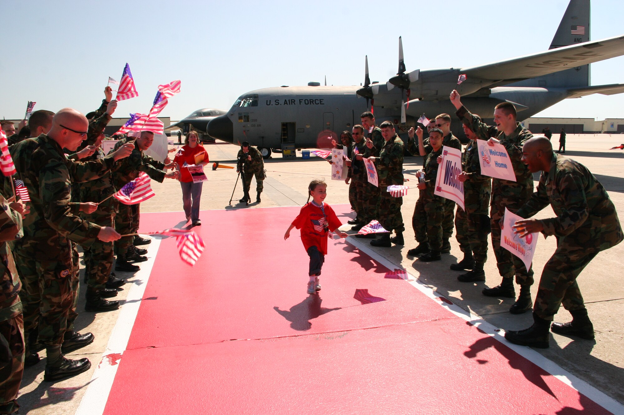 Riley Michaud, daughter of Capt. Matt Michaud, 393d Bomb Squadron, is welcomed home after a mock ‘deployment’ Saturday during Operation Spirit. The operation provided military children th opportunity to experience a ‘deployment’ at their level. (U. S. Air Force photo/Airman 1st Class Stephen Linch)