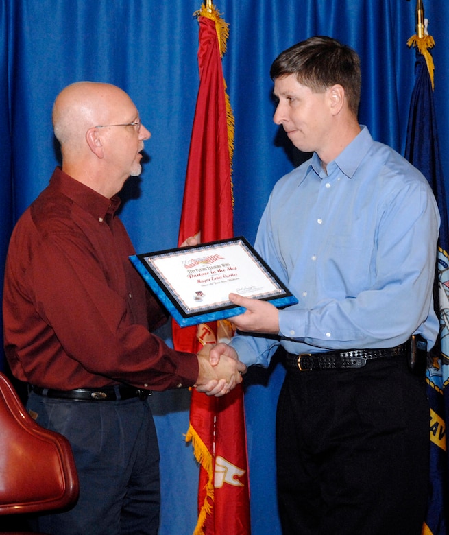 Enid Mayor Ernie Currier receives a certificate of induction as Vance Air Force base's newest Partner in the Sky from Col. Richard Klumpp Jr., 71st Flying Training Wing commander. The presentation was made Saturday during the wing's farewell to the Curriers. (U.S. Air Force photo by Terry Wasson) 