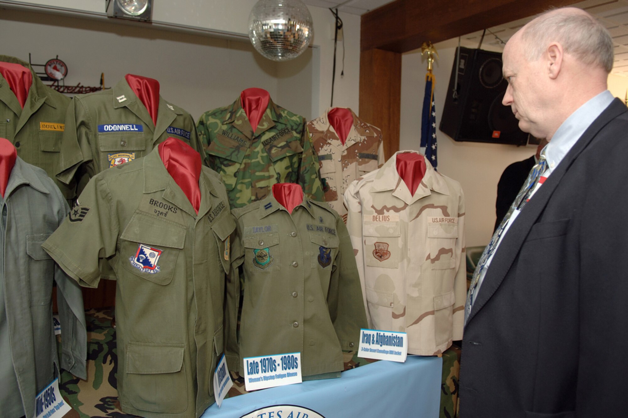 A military retiree pauses to look at a display of vintage Air Force uniforms at the 27th Annual Hanscom Retiree Day Saturday.  The display, which is part of a larger collection, by Will Schaefer is in honor of the Air Force’s 60th Anniversary. The event, sponsored by the Hanscom Retiree Activities Office, featured more than 35 information service tables representing on- and off-base agencies. (US Air Force Photo by Jan Abate)