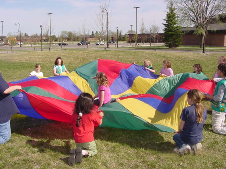 GRAND FORKS AIR FORCE BASE, N.D. ? Junior Girl Scout Troop 1096 play a parachute game at their end of school meeting after picking up trash at Twining school.  (Courtesy photo/Ms. Tricia Castilleja)
