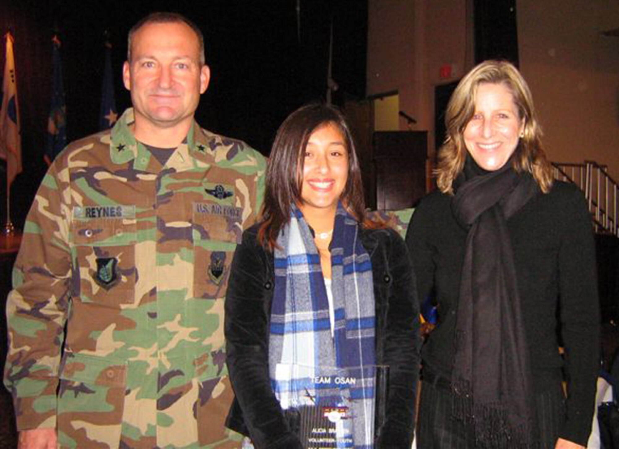 OSAN AIR BASE, Republic of Korea --  Alicia Bratten, Pacific Air Force's Youth of the Year, poses with Brig. Gen. Joe Reynes, 51st Fighter Wing commander, and Mrs. Karen Reynes. (Courtesy photo)