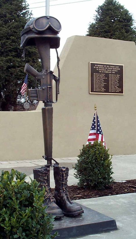 An actual-size bronze casting of the boots, M-16 rifle and helmet symbolic of the fallen soldiers stands to the left of the 14th Quartermaster Detachment Memorial at the Army Reserve center in Greensburg, Pa. Photo by Linda D. Kozaryn. 