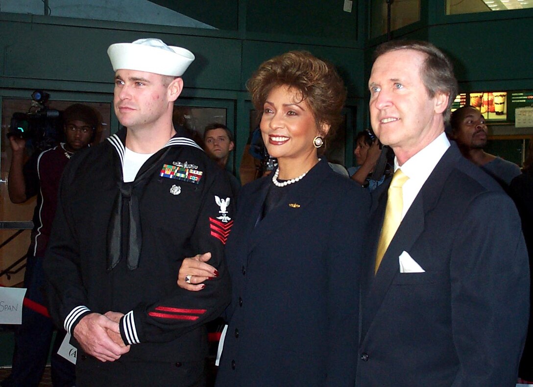 Navy Petty Officer First Class Eric Tilford (left), a photographer's mate and a diver from Lamoni, Iowa, escorts Defense Secretary William S. Cohen and his wife, Janet Langhart Cohen, at the Washington premiere of "Men of Honor," a film about Navy Master Chief Petty Officer Carl M. Brashear. Tilford recalled that he met Brashear when he went through diving school nearly 10 years ago, but at the time didn't realize he was one of the Navy's unsung heroes. Photo by Linda D. Kozaryn. 