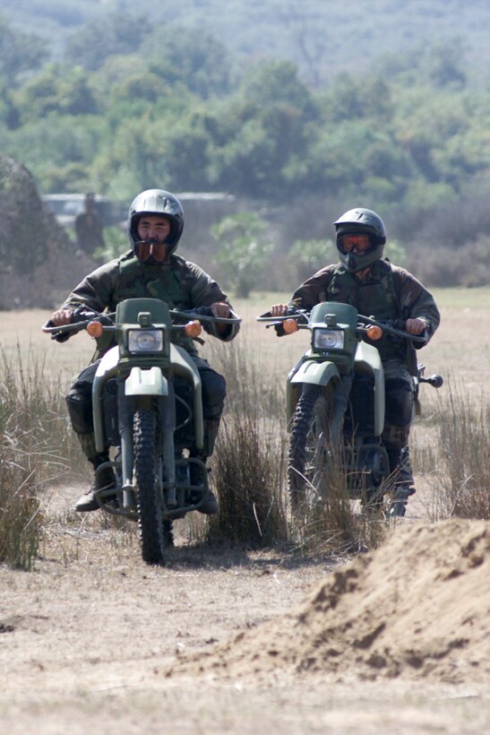 Pfc. Chris Robertson and Lance Cpl. Douglas Quaderer return to their battalion's command post during exercise Atlas Hinge in Tunisia. Both Marines are motorcyclists in the 26th Marine Expeditionary Unit. The annual bilateral exercise, held Sept. 15-20 this year, involved about 1,500 U.S. Marines and 700 Tunisian service members. Photo by Sgt. Brook R. Kelsey, USMC. 