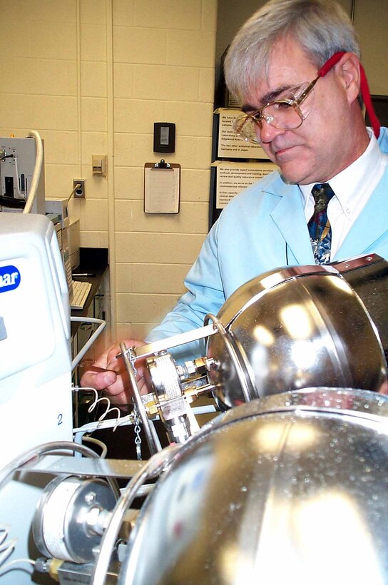 Lawrence Clark, a chemist at the U.S. Army Center for Health Promotion and Preventive Medicine at Aberdeen Proving Ground, Md., connects a summa canister to a Tekmar autocan system. The canisters are used to collect air samples in deployment locations. The autocan system then introduces the samples into a state-of-the-art analytical system. Photo by Staff Sgt. Kathleen T. Rhem, USA.