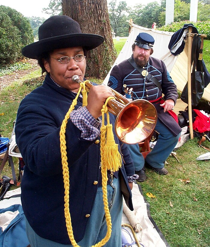 To best of anyone's knowledge, there were not any women buglers during the Civil War, but that doesn't stop Anita Henderson of Columbia, Md., from participating in reenactment sessions at Arlington (Va.) National Cemetery as a Union Army bugler. Photo by Rudi Williams