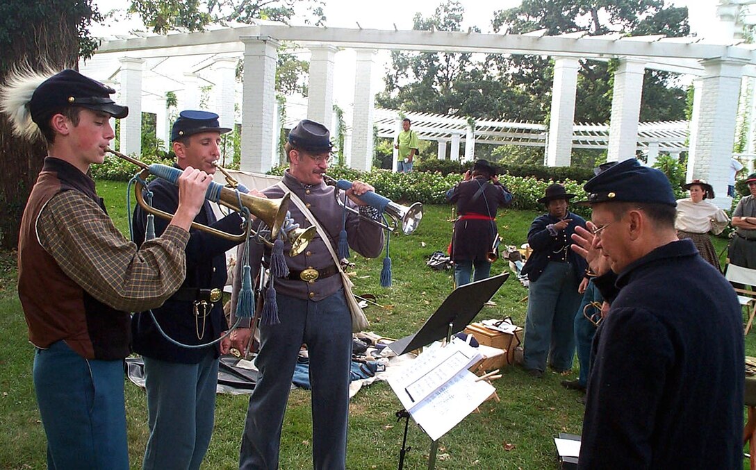 Civil War bugler reenactor Air Force Master Sgt. Jari Villanueva, right