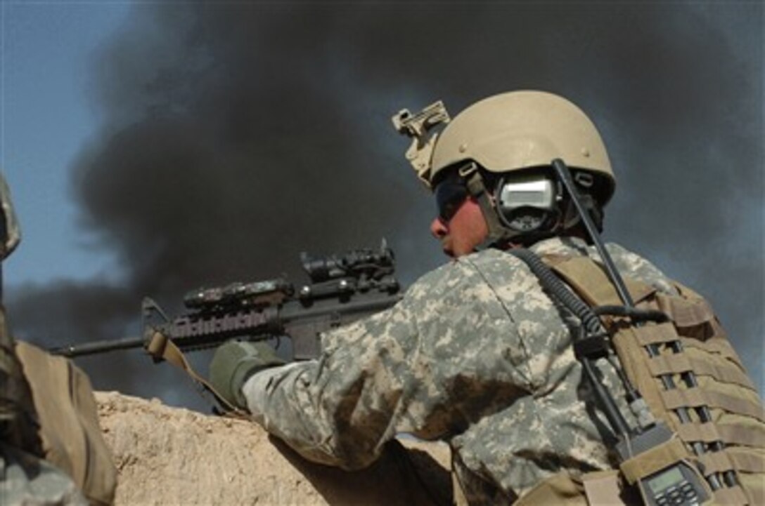 A U.S. Army Special Operations soldier scans for insurgents during an engagement in the Sangin District area, Helmand Province, Southern Afghanistan on April 10, 2007.  Soldiers with Combined Joint Special Operations Task Force - Afghanistan have been conducting operations to eliminate insurgents and promote peace and stability in the area.  