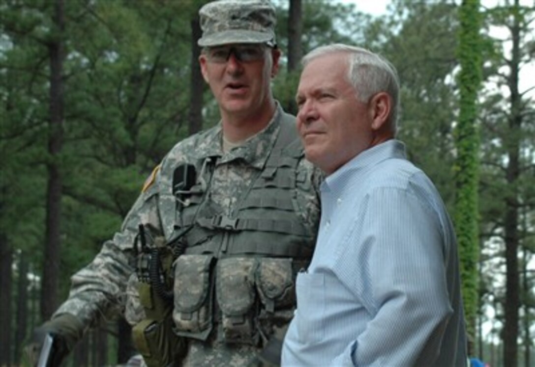 Defense Secretary Robert M. Gates and Brig. Gen. Daniel Bolger, commander of the Joint Readiness Training Center and Fort Polk,  talk while on their way to observe training at the Joint Readiness Training Center and Fort Polk, La.,  May 4, 2007.