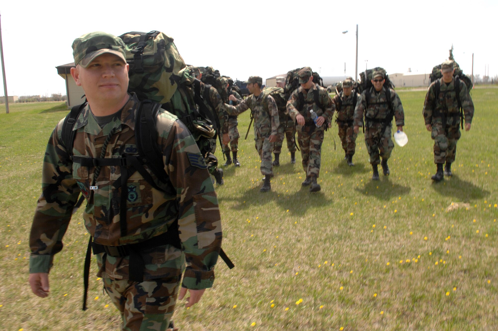 Airmen from the 5th Security Forces Squadron take part in a "ruck march" May 3 to show support for a fellow squadron member injured in Iraq (U.S. Air Force photo/Senior Airman Stacy Moless)
