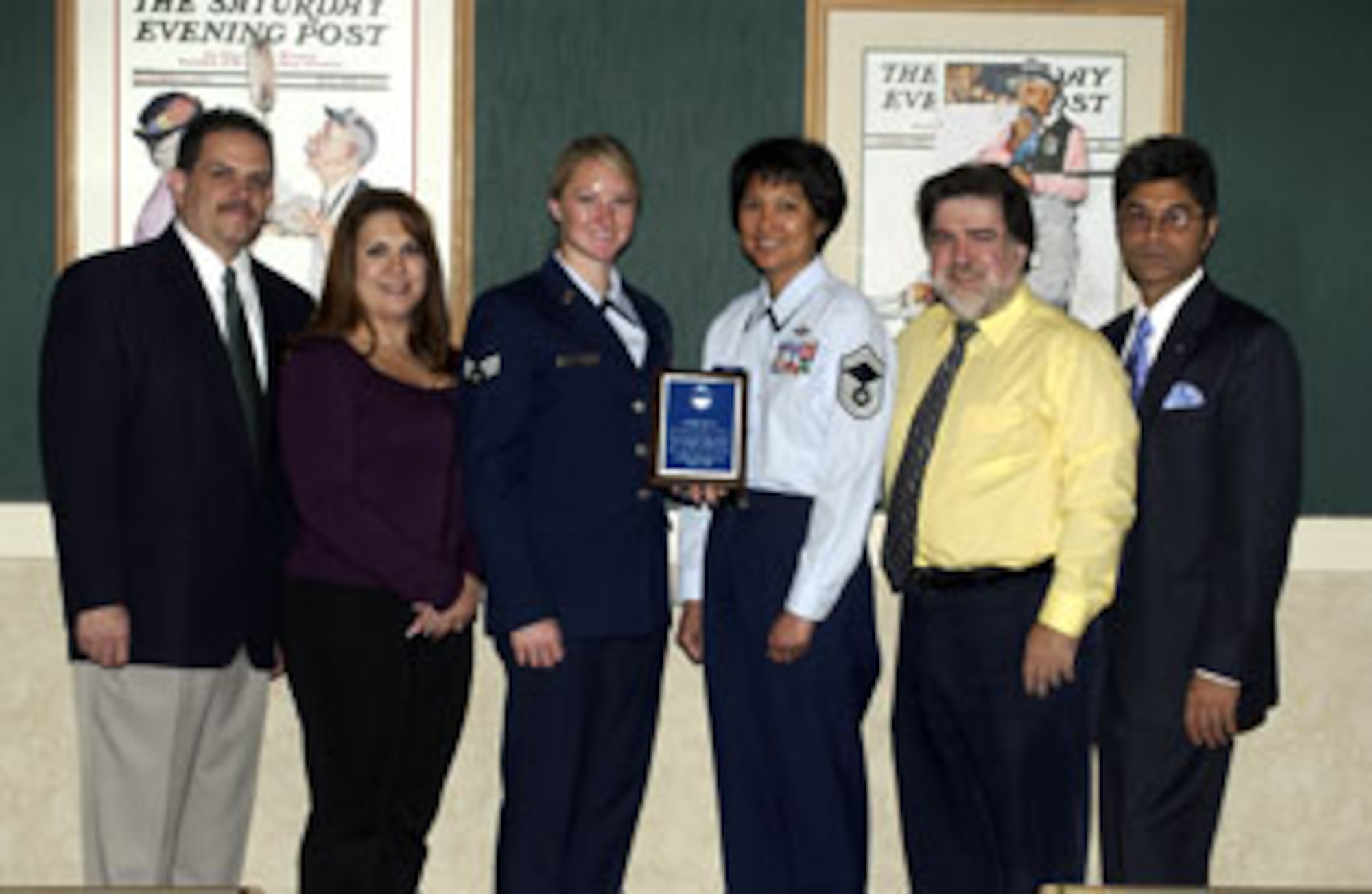 Senior Airman Lyndsey Wisniewski (holding plaque), 452nd Aeromedical Evacuation Squadron at March Air Reserve Base, was recognized at the April 20 Wake Up Moreno Valley, a monthly event by the Moreno Valley Chamber of Commerce. Senior Airman Wisniewski was recently named 452nd Air Mobility Wing Airman of the Year. Each month, the Chamber recognizes a different person from one of the various units at March. (Left to right) Oscar Valdepena, executive director of the Moreno Valley Chamber of Commerce, Julie Reyes, chairman for the Moreno Valley Chamber of Commerce, Airman Wisniewski, Senior Master Sgt. Cecile Tamayo, 452nd AES training flight supervisor, Chamber Director Harold Trubo and Chamber Director Jamil Dada. (U.S. Air Force photo by Staff Sgt. Amy Abbott)