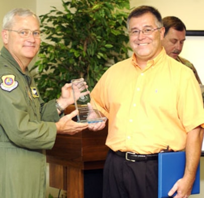 Brig. Gen. James Melin (left), 452nd AMW Commander at March Air Reserve Base, presents the AFRC Outstanding Weapons Safety Civilian of the Year award to Vic Flores. (U.S. Air Force photo by Staff Sgt. Amy Abbott, 452 AMW/PA)