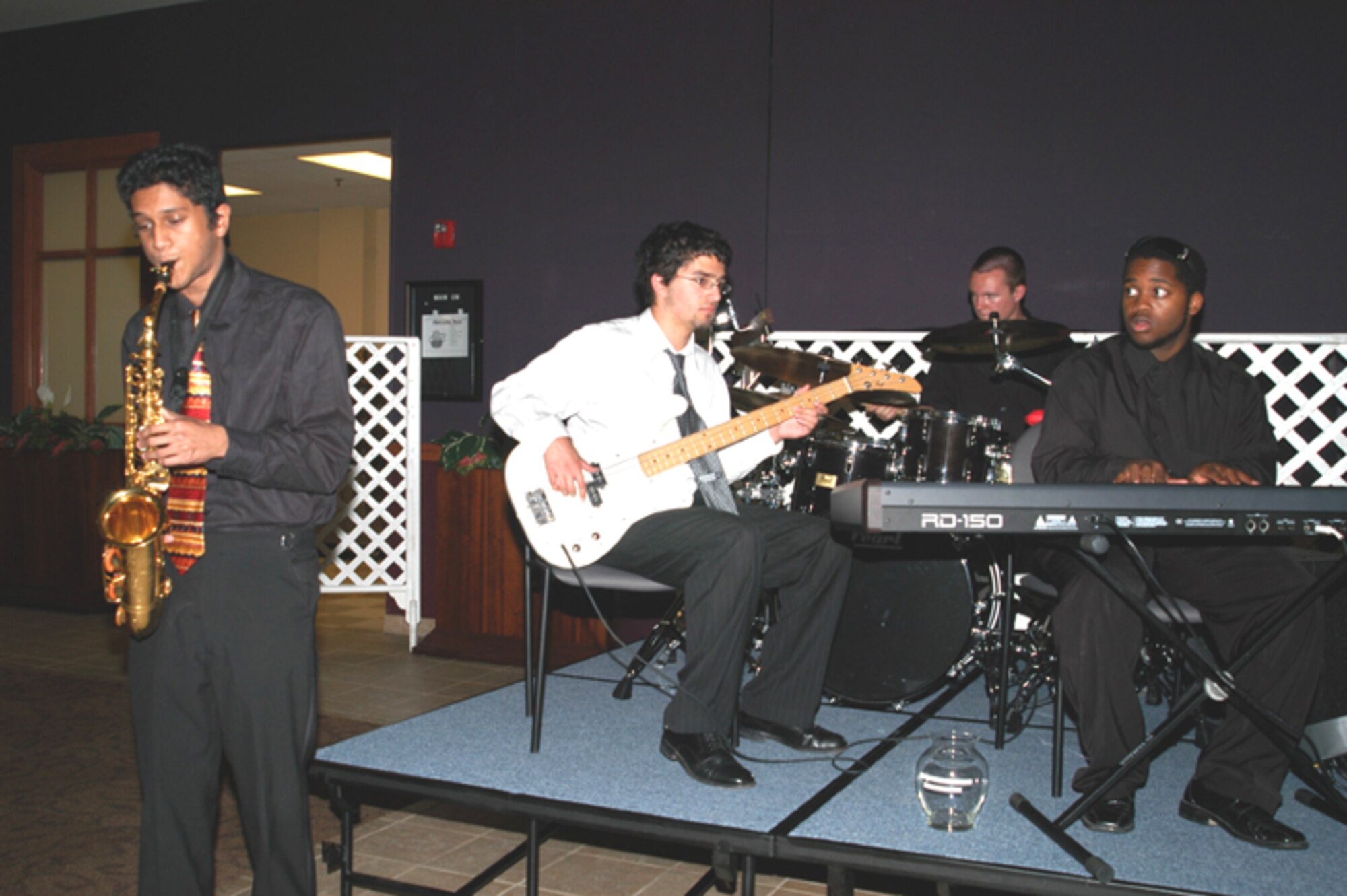 GRISSOM AIR RESERVE BASE, Ind -- The Kokomo High School Jazz Quartet performs during the social hour at the "State of the Base" address on May 4.  More than 200 community leaders and base personnel packed the dining facility to hear Brig. Gen. Dean Despinoy's presentation on the current state of affairs at the base.  Jazz Quartet members are Vivek Hadley (bass),  Om Srivastava (saxophone), Ryan Harvey (drums) and Bryant Tollers (piano).  (U.S. Air Force photo/Senior Airman Ben Mota)
