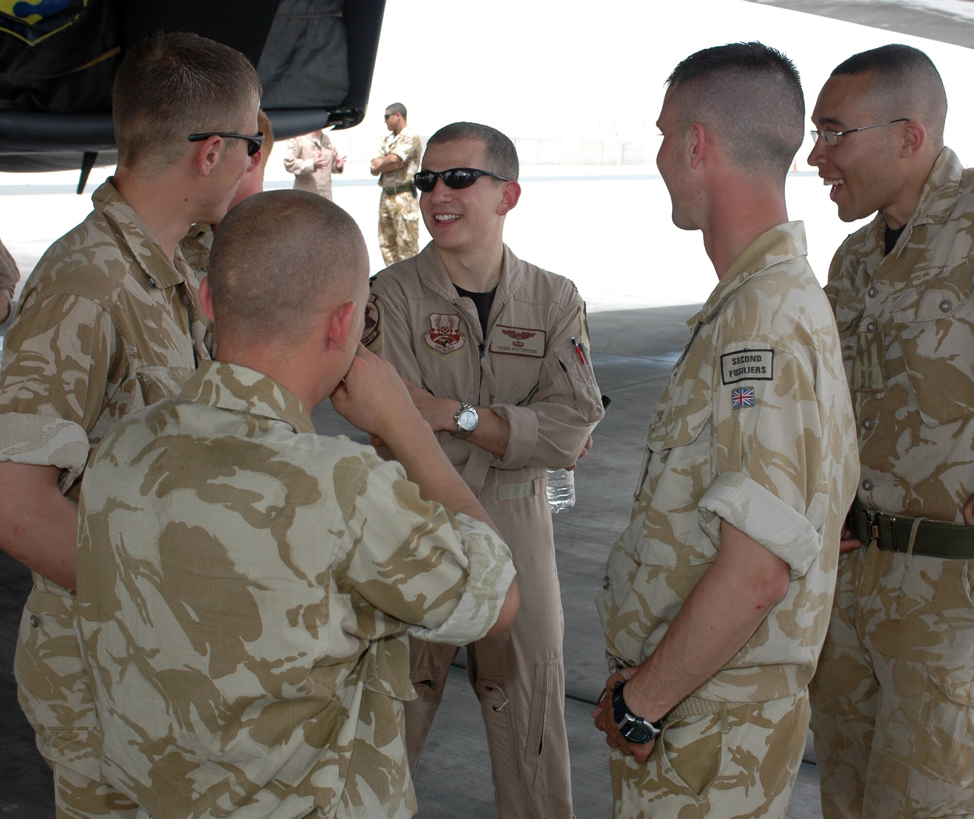 Capt. Todd Patterson, 34th Expeditionary Bomb Squadron pilot, chats with Infantrymen from the Royal Regiment of Fusiliers Wednesday. The “Thunderbirds” were called upon daily to provide close air support for the Fusiliers through bombing and shows of force and presence. (U.S. Air Force photo/Senior Airman Erik Hofmeyer)