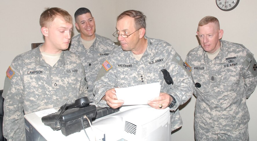 OSAN AIR BASE, Republic of Korea -- During a unit visit Friday, Pfc. David Lampson, left, an automated logistical specialist in Fox Maintenance Company, 1-43 Air and Missile Defense Battalion, 35th Air Defense Artillery Brigade, received a visit from Lt. Gen. David Valcourt, 8th U.S. Army commanding general, and Command Sgt. Maj. Barry Wheeler, 8th U.S. Army CSM. Private First Class Lampson had the seldom sought after honor of having his paperwork and Military Occupational Specialty knowledge put to the test by his commanding general, while Lt. Col. John Chavez, 1-43 AMD Battalion commander, looks on. For his bravery, Private First Class Lampson received the CG’s coin. (U.S. Army photo)
