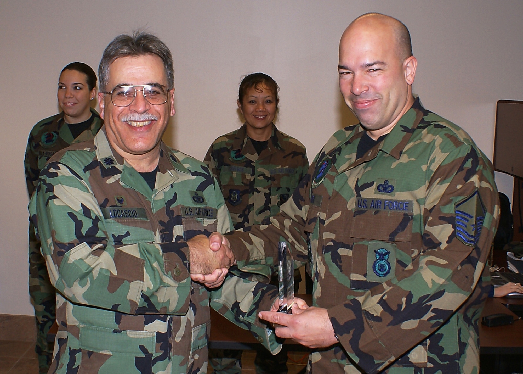 482nd Security Forces Squadron commander Lt. Col. Frank Locascio (left) congratulates Master Sgt. Michael Cohen, Combat Arms Instructor, May 5 for earning the Unit Senior NCO of the Quarter award. Capt. Eduardo Martinez won for Unit Junior Officer of the Quarter, and Staff Sgt. Timothy Hilgeman won for Unit NCO of the Quarter. (U.S. Air Force photo/Dan Galindo)