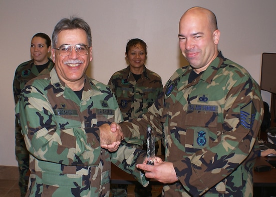 482nd Security Forces Squadron commander Lt. Col. Frank Locascio (left) congratulates Master Sgt. Michael Cohen, Combat Arms Instructor, May 5 for earning the Unit Senior NCO of the Quarter award. Capt. Eduardo Martinez won for Unit Junior Officer of the Quarter, and Staff Sgt. Timothy Hilgeman won for Unit NCO of the Quarter. (U.S. Air Force photo/Dan Galindo)