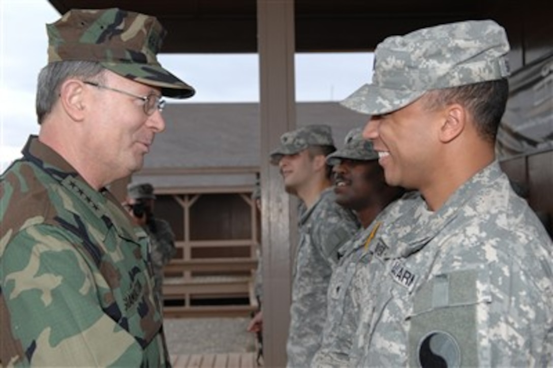 U.S. Navy Adm. Edmund P. Giambastiani, vice chairman of the Joint Chiefs of Staff, meets with Army Spc. Matthew Shaver, training noncommissioned officer with Task Force Falcon, at Multi-National Task Force-East at Camp Bondsteel, Kosovo, May 4, 2007.
