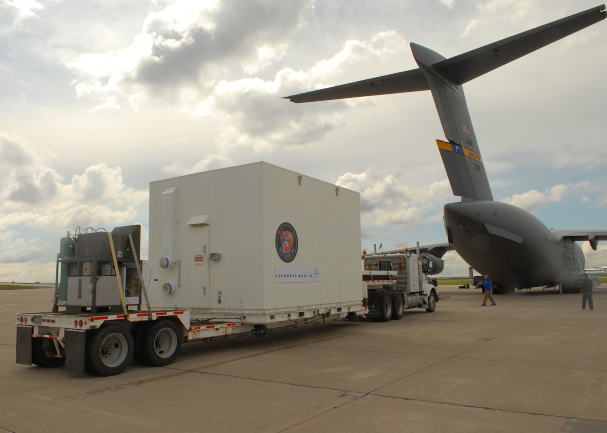 BUCKLEY AIR FORCE BASE, Colo. -- David Smith, a member from Lockheed Martin?s load crew, lines up a flat-bed trailer holding NASA's Phoenix Mars Lander.
The lander, which was built at Lockheed Martin Space Systems Company's Waterton Canyon facilities in Littleton, Colo., was loaded on a C-17 for transportation to NASA's Kennedy Space Center in Florida for final test and launch preparations. The Phoenix lander is slated for liftoff aboard a Delta II launch vehicle in early August. 

Phoenix is the first mission of NASA's Mars Scout Program. The spacecraft will land on the icy northern latitudes of Mars. During its approximately 90-day mission, Phoenix will dig trenches with its robotic arm into the frozen layers of water below the surface. The spacecraft will use various on-board instruments to analyze the contents of the ice and soil; all in the hopes of finding organic compounds that are necessary for life. (U.S. Air Force photo by Airman 1st Class Alex Gochnour)
