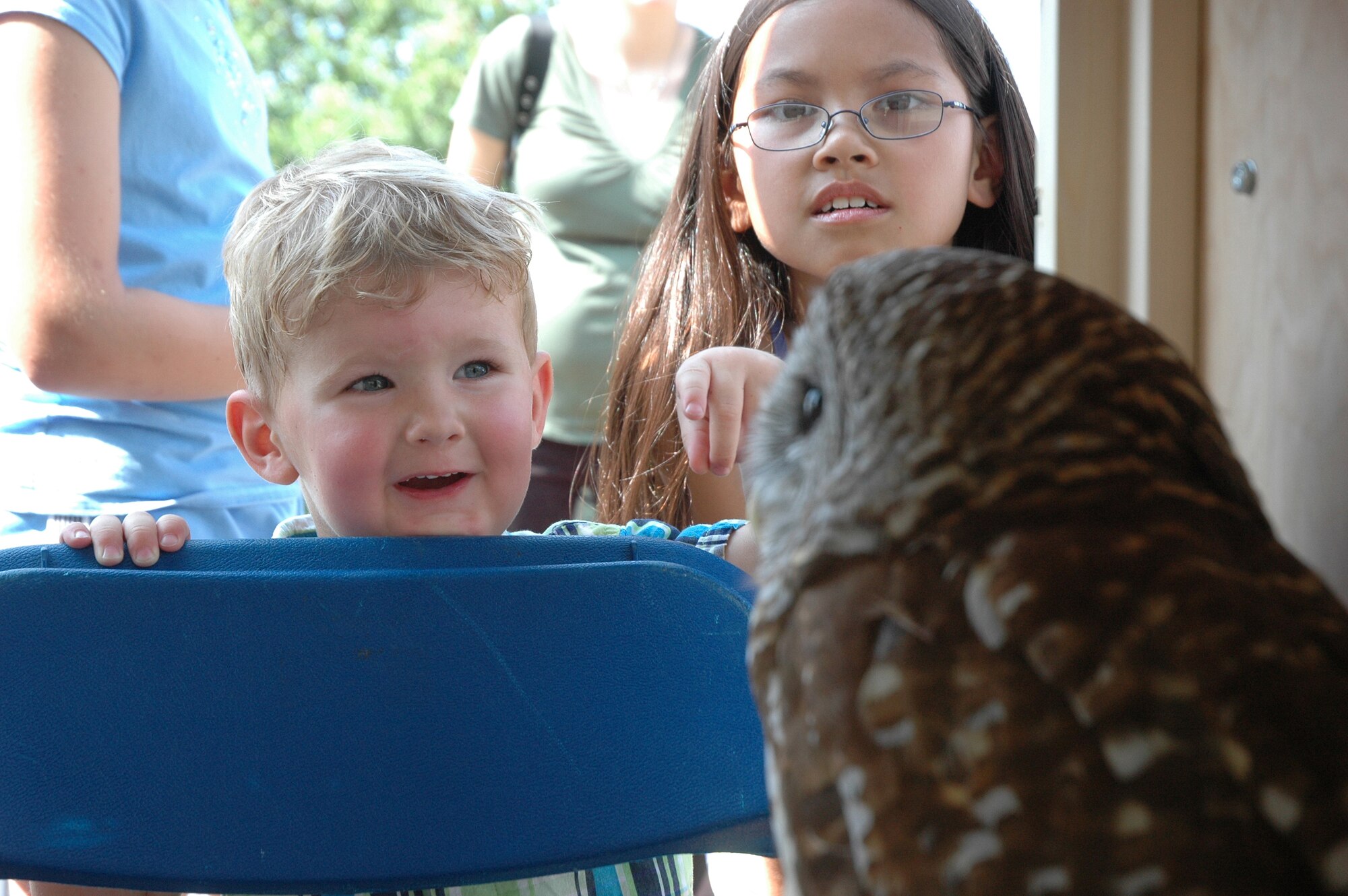 EGLIN AIR FORCE BASE, Fla. -- Michael Garden, 2, and Alesha Fairchild, 8, admire April, a barn owl and educational animal brought to Eglin's annual Pet Bazaar by the Emerald Coast Wildlife Refuge May 5. The event is sponsored for pet owners and offered a pet show, vendors, a military working dog demonstration and visits by McGruff the Crime Dog and Sparky the Fire Dog. (U.S. Air Force photo by Staff Sgt. Mike Meares)