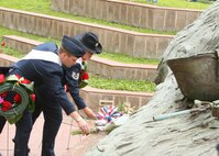Lackland Ambassadors Capt. Brent Dishman and Tech. Sgt. Magdalena Cortez place flowers April 29 at the Vietnam Veterans Memorial in San Antonio's Veterans Memorial Plaza during an All Veterans Memorial Service. Wreaths also were laid by other military ambassadors and representatives of veterans' groups during the solemn program on the final day of Fiesta San Antonio. (USAF photo by Robbin Cresswell)
