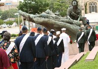 Military ambassadors from Lackland and other city installations, as well as representatives from veterans groups, bow their heads in prayer April 29 during an All Veterans Memorial Service in Veterans Memorial Plaza at the Municipal Auditorium. The solemn Fiesta San Antonio event is sponsored annually by Alamo Chapter 366, Vietnam Veterans of America, as "a salute to the dedication and sacrifices of the brave men and women who have served and those who are serving in the U.S. military to protect American freedom." In the background is the
Vietnam Veterans Memorial's Monument for the Battle of Hill 881 South that was dedicated in November 1986 in a ceremony attended by 6,000 people, including the former commander of U.S. forces in Vietnam, retired Gen. William C. Westmoreland, who gave the keynote address. (USAF photo by Robbin Cresswell)