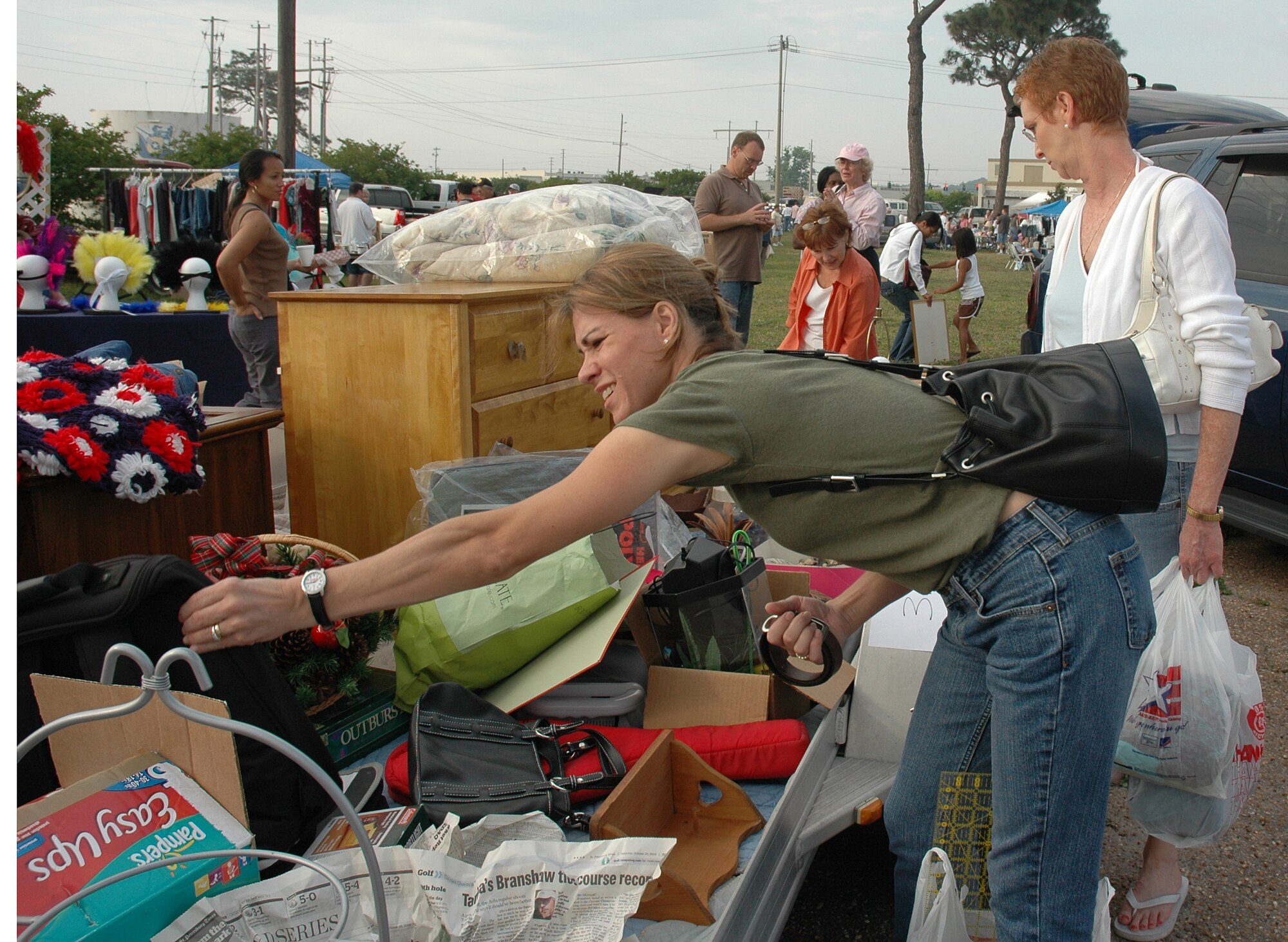 EGLIN AIR FORCE BASE, Fla - A customer reaches for merchandise for sale May 5 at the annual Spring Parking Lot Sale. About 100 families set out used items for sale. The 96th Services Squadron lodging office also was also on hand, selling furniture, toasters, paintings and food. (U.S. Air Force photo by Staff Sgt. LuCelia Ball)