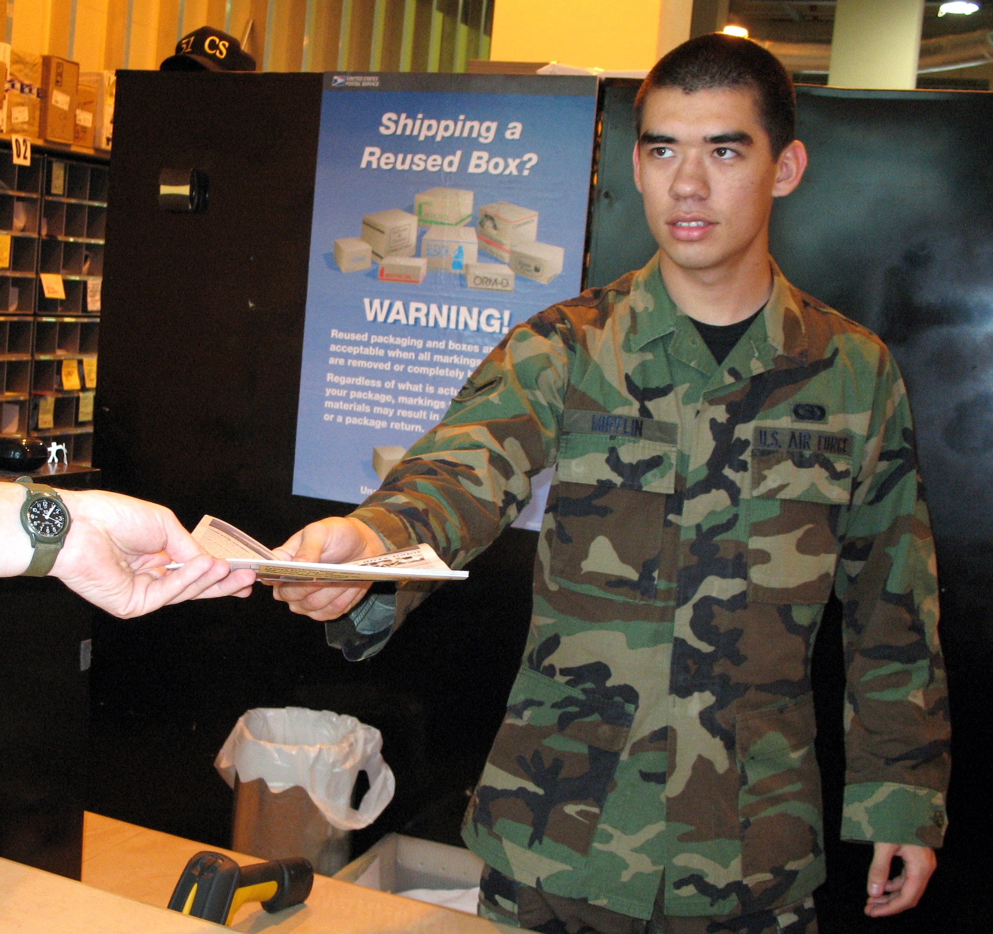 Airman Ron Mifflin works at the pick-up window May 4 at the Aviano Air Base Post Office. Airman Mifflan is one of many Airman doing details during his first week attending the First Term Airmen's Center. During FTAC, first-term Airman do base details as well as attend briefings to help orient them to their new base. (U.S. Air Force photo/Airman 1st Class Michael Williams)
